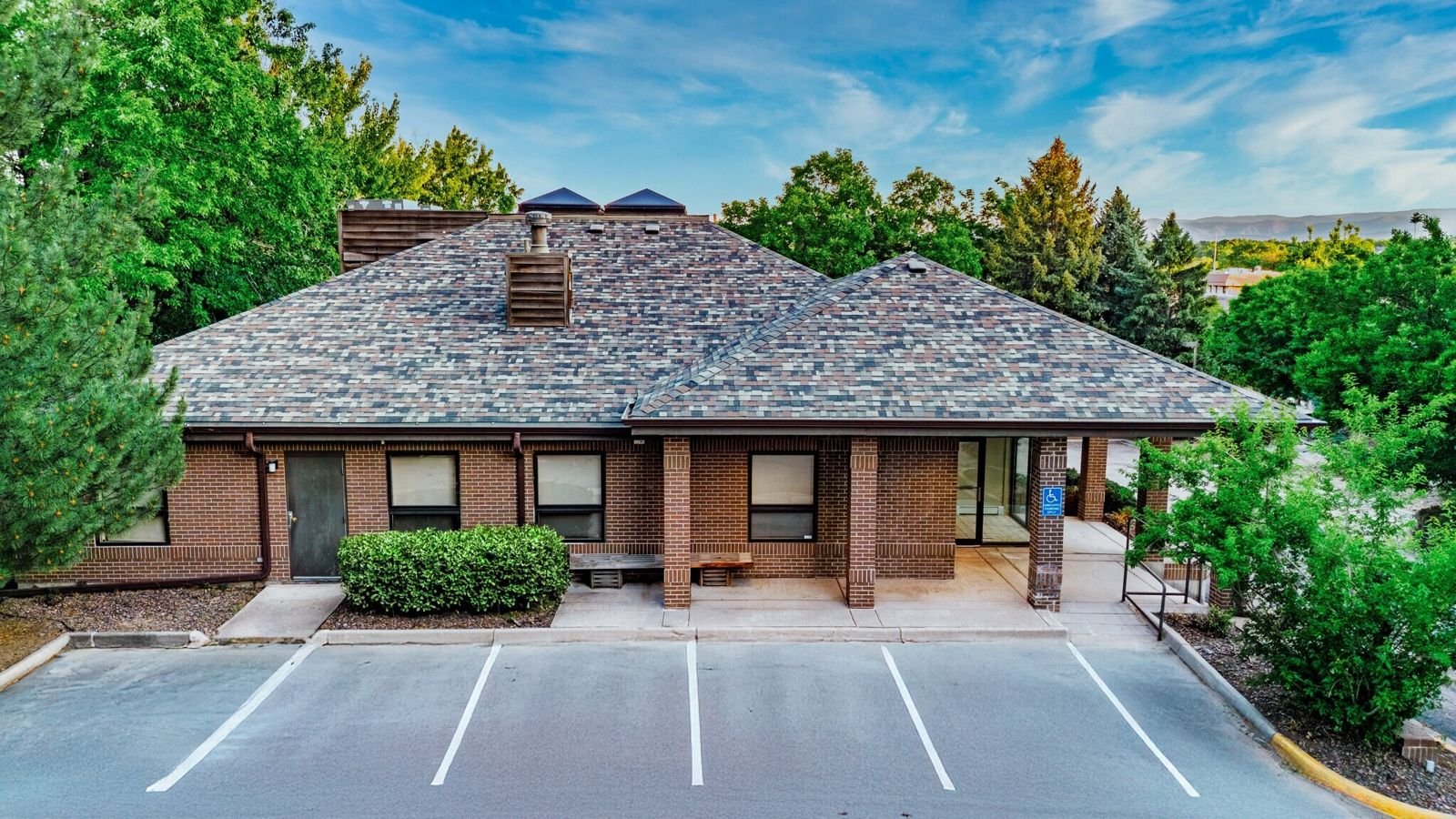 Brick medical office building exterior with parking at 7515 W Yale Ave, Denver