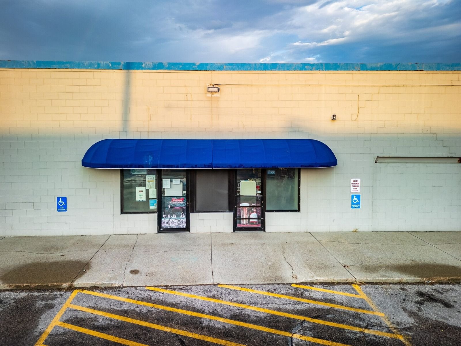 Storefront entrance with blue awning at Midland Shopping Center, 909 E St Patrick St, Rapid City SD
