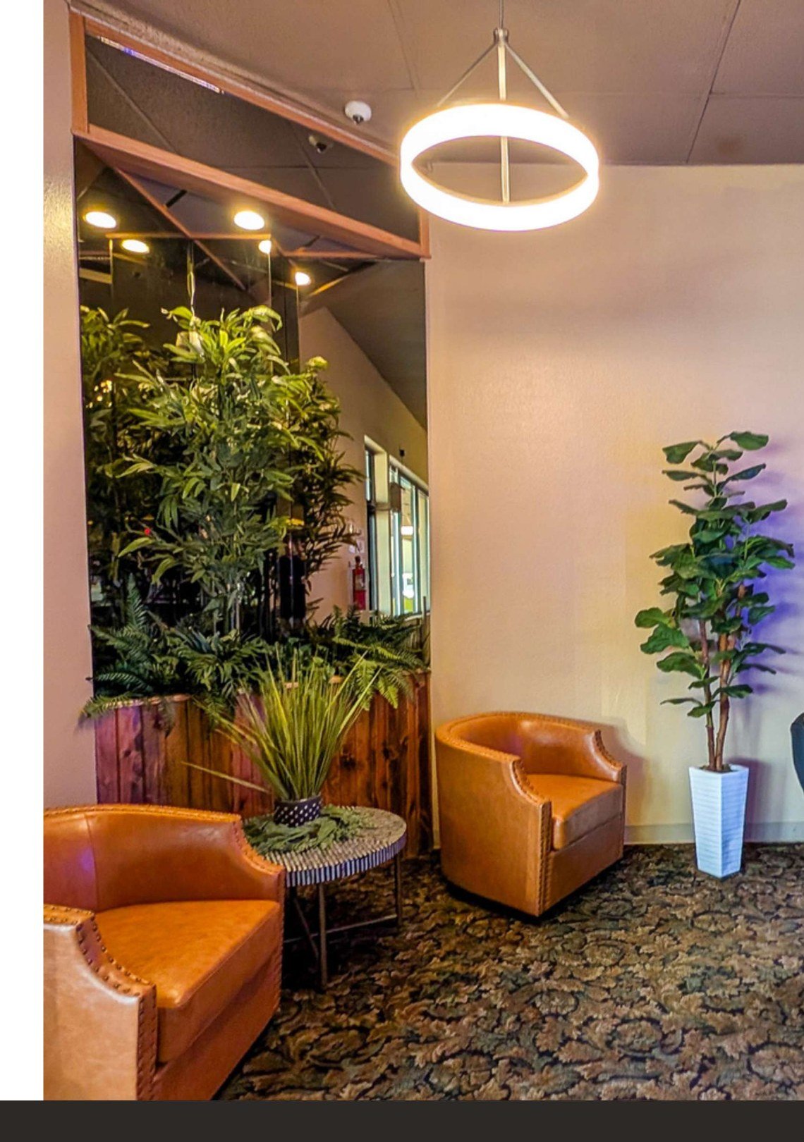 Lobby with leather armchairs and ring pendant light at Midland Shopping Center, 909 E St Patrick St, Rapid City SD