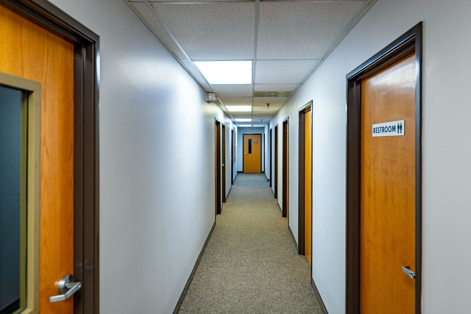 Office suite hallway with wood doors at Midland Shopping Center, Rapid City